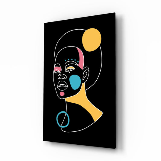Angled perspective view of black glass wall art featuring a colorful abstract female portrait with yellow moon and geometric shapes against dark background.