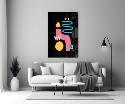 Abstract canvas with pink, yellow, and cyan geometric shapes on black background, displayed above white sofa in modern living room.