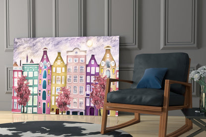 Colorful glass panel featuring whimsical painted townhouses in pink, yellow, and purple with blooming trees, displayed in modern living room setting.