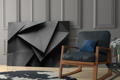 Modern living room interior featuring abstract geometric glass wall art with black and gray folded shapes, wooden armchair with dark upholstery, and paneled wall backdrop.