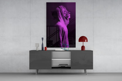 Purple neon-lit lion head glass art displayed above a gray media console in a minimalist interior setting.