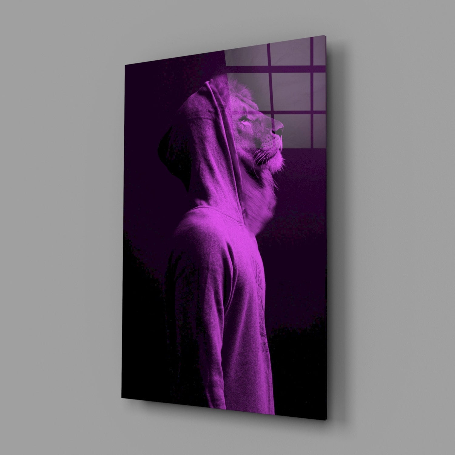 A lion's head in profile, bathed in magenta light, displayed on a glass panel mounted against a gray wall.