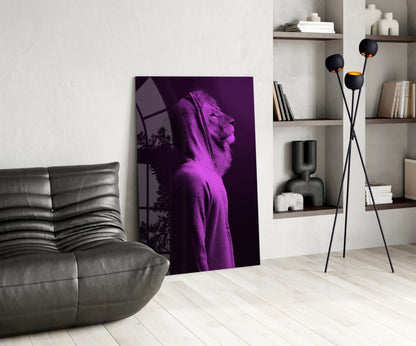 Purple neon lion head glass wall art leaning against white wall in modern living room with gray sofa and shelving.
