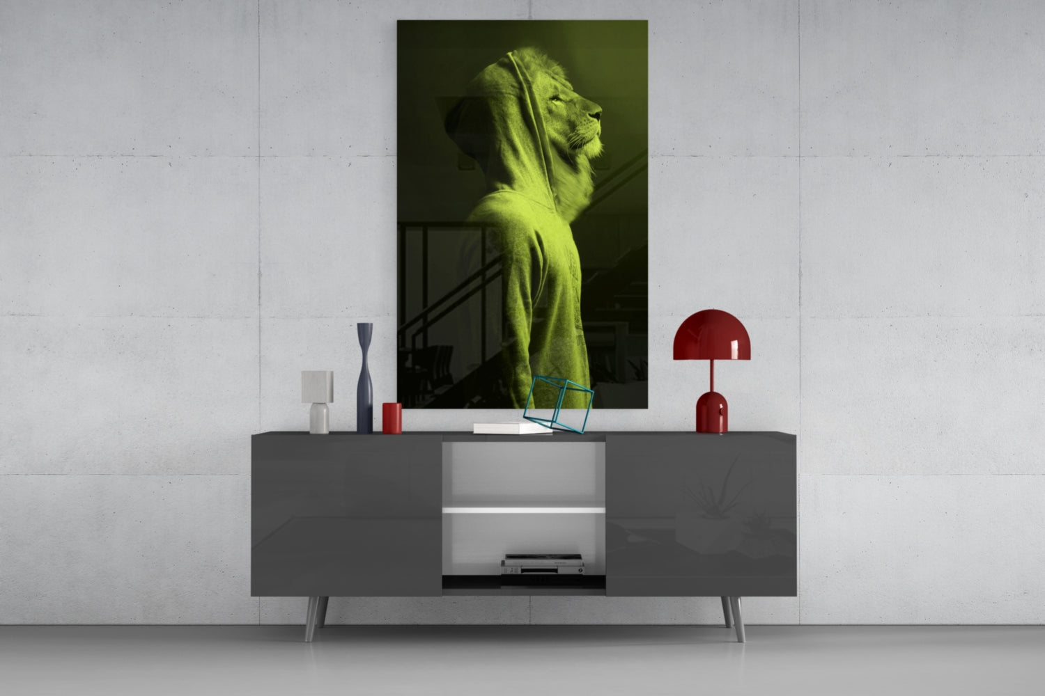 Green lion head glass wall art displayed above gray sideboard with red lamp and decorative accessories in modern interior setting.