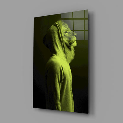 Angled perspective of illuminated lion head glass wall art in neon yellow-green tones against dark background with grid window pattern.
