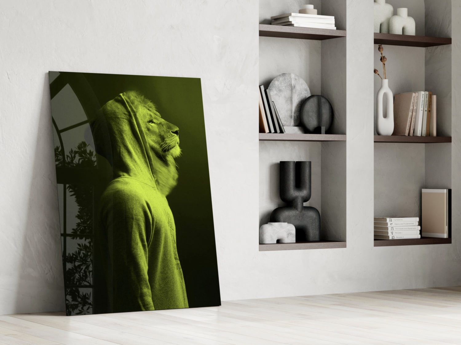 Green lion head glass wall art leaning against white wall beside floating shelves displaying books and decorative objects.
