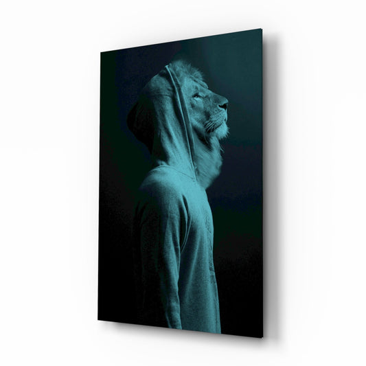 Profile view of a lion's head wearing a teal hoodie against a dark background on glass wall art.