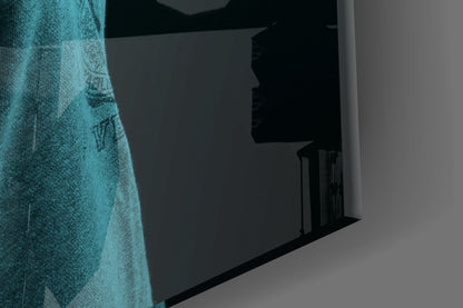Blue lion head glass wall art displayed at an angle showing textured turquoise surface against dark interior wall.