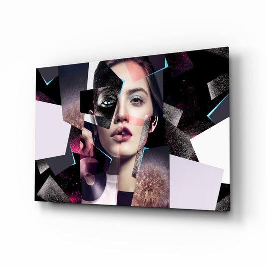 Modern glass wall art featuring a woman's face fragmented by geometric shapes in black, white, pink, and cyan with glitter accents, displayed at an angled perspective.