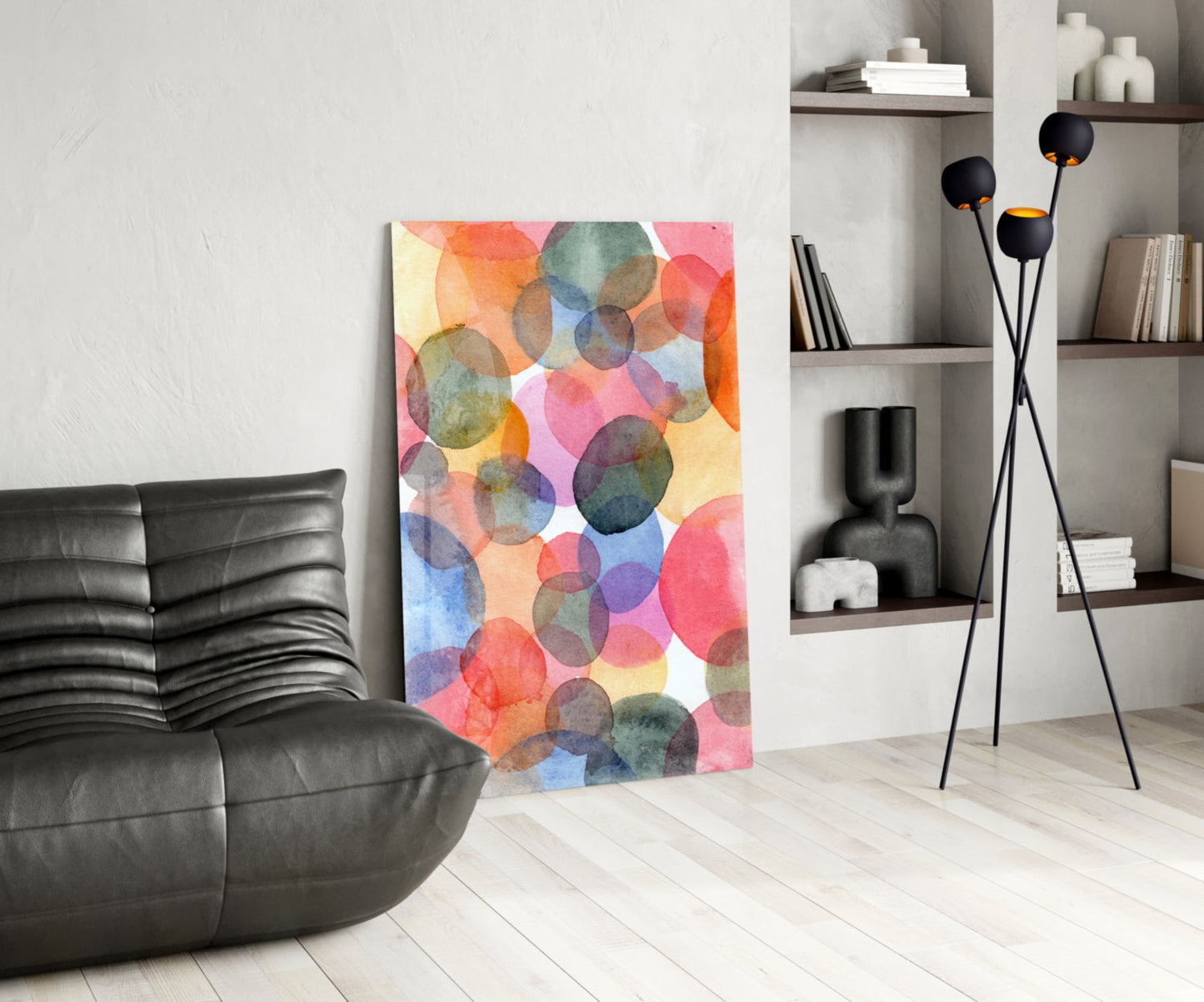 Watercolor glass wall art with overlapping translucent circles in pink, orange, blue, and green tones displayed in modern living room setting.