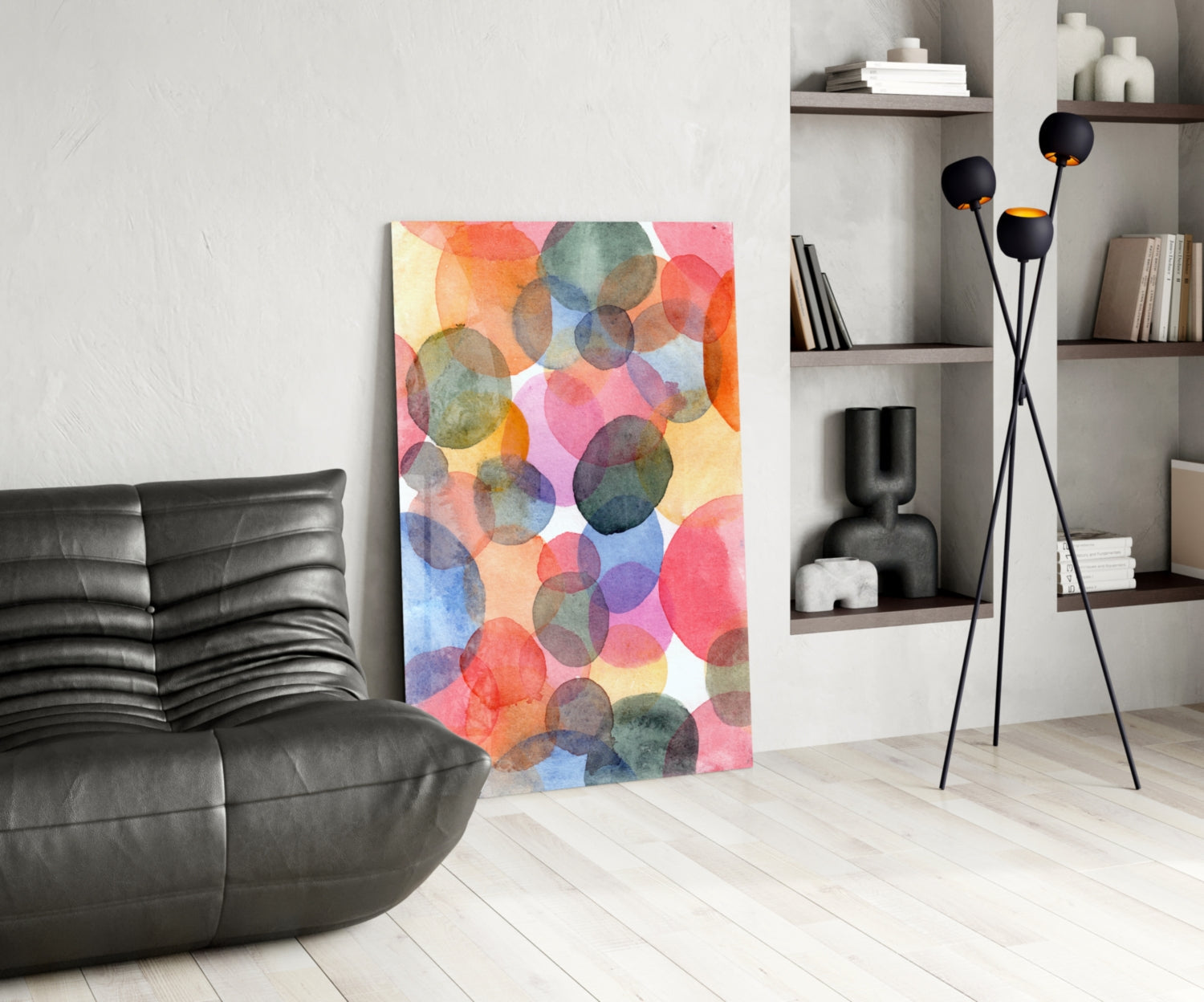 Watercolor glass wall art with overlapping translucent circles in pink, orange, blue, and green tones displayed in modern living room setting.