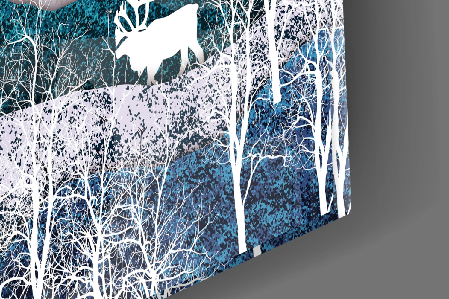 Angled view of glass wall art depicting a snowy forest landscape with white birch trees, blue background, and a white flying bird silhouette.