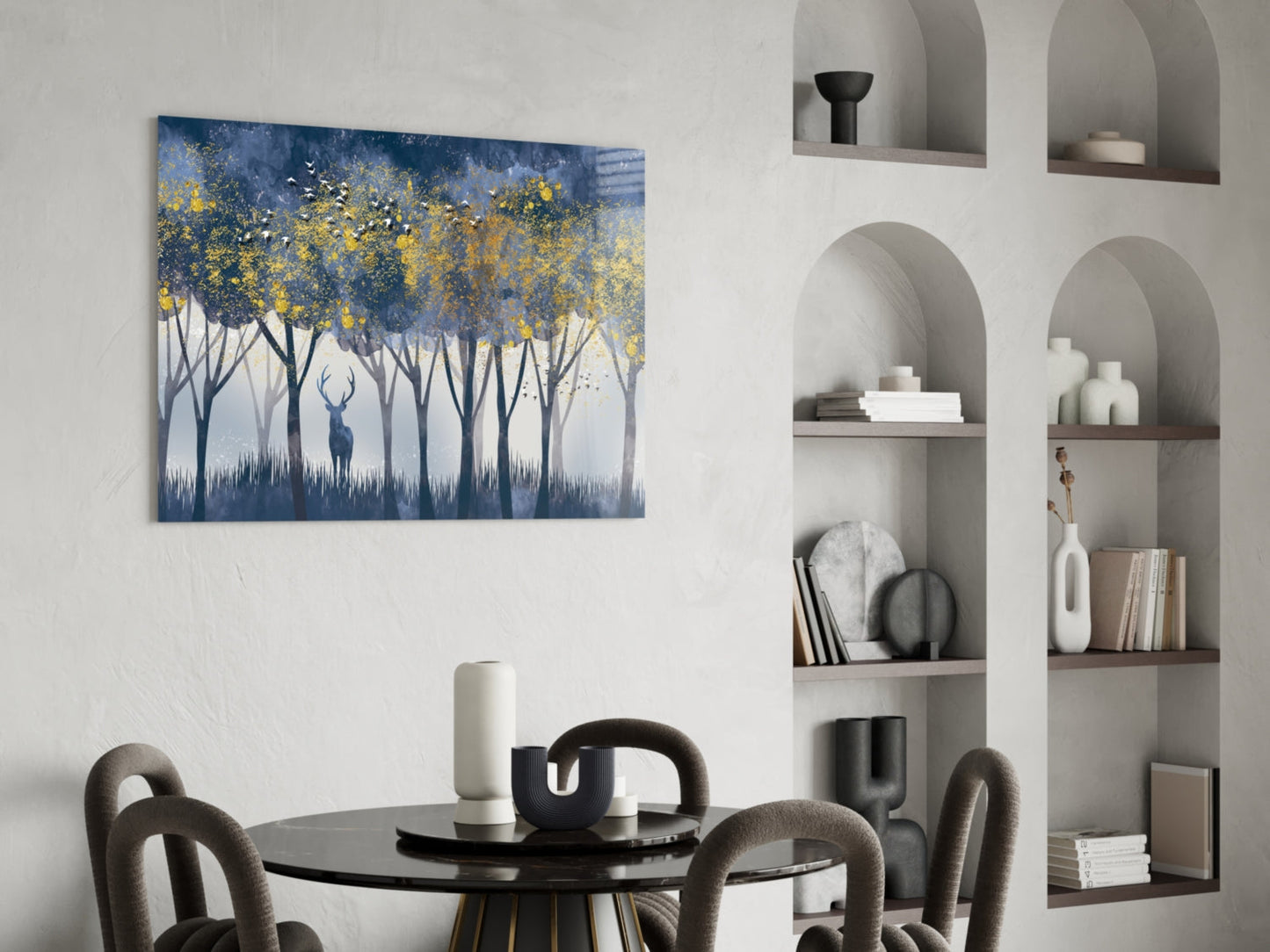 Glass wall art depicting a lone deer silhouette beneath yellow-leafed trees against blue and white background, displayed above dining table.