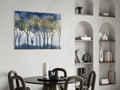 Glass wall art depicting a lone deer silhouette beneath yellow-leafed trees against blue and white background, displayed above dining table.