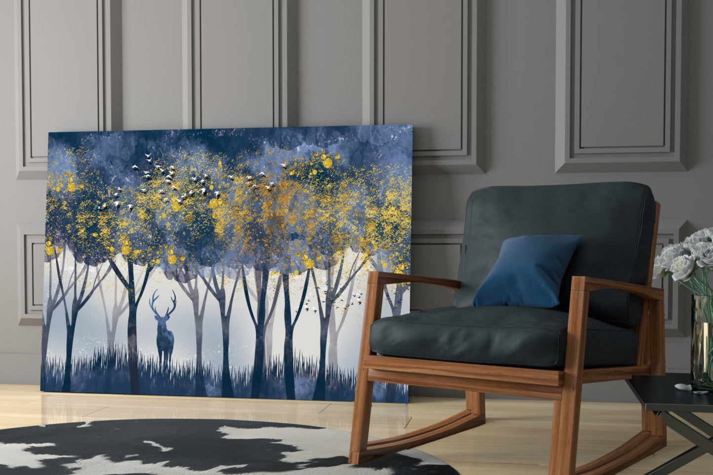 Lonely Deer Glass Wall Art displayed on floor beside wooden rocking chair, showing blue forest with golden foliage and silhouetted deer.