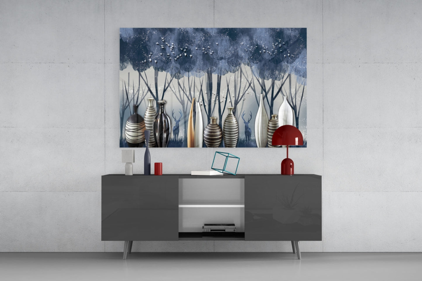 Modern living room display with glass wall art depicting blue trees and striped vases above dark gray media console with red accents.
