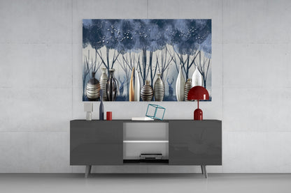 Modern living room display with glass wall art depicting blue trees and striped vases above dark gray media console with red accents.