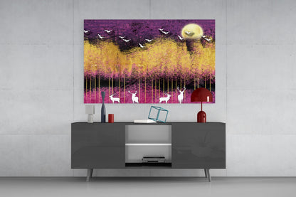 Modern living room with glass wall art above dark grey media console, featuring purple, yellow, and pink landscape with silhouetted deer and birds.