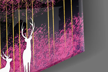 Close-up angled view of glass wall art featuring white deer silhouettes against pink and black textured background with gold vertical lines.