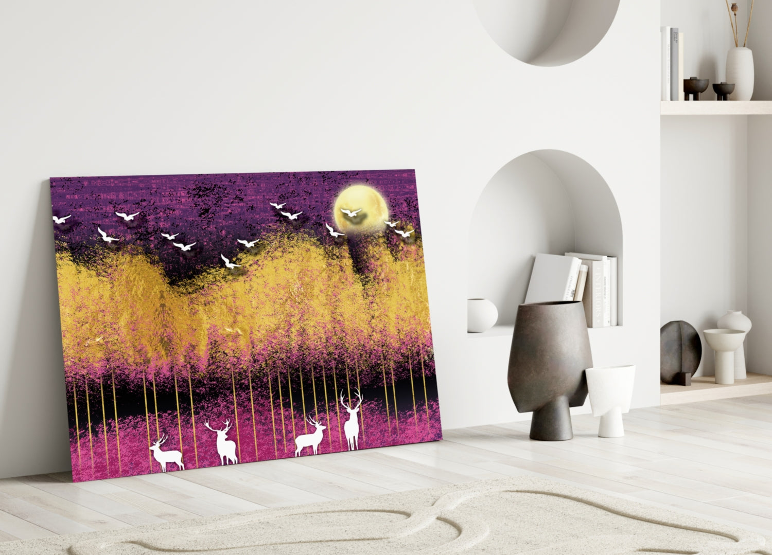 Glass wall art leaning against white wall displays purple, yellow, and gold landscape with silhouetted deer, birds, and full moon.