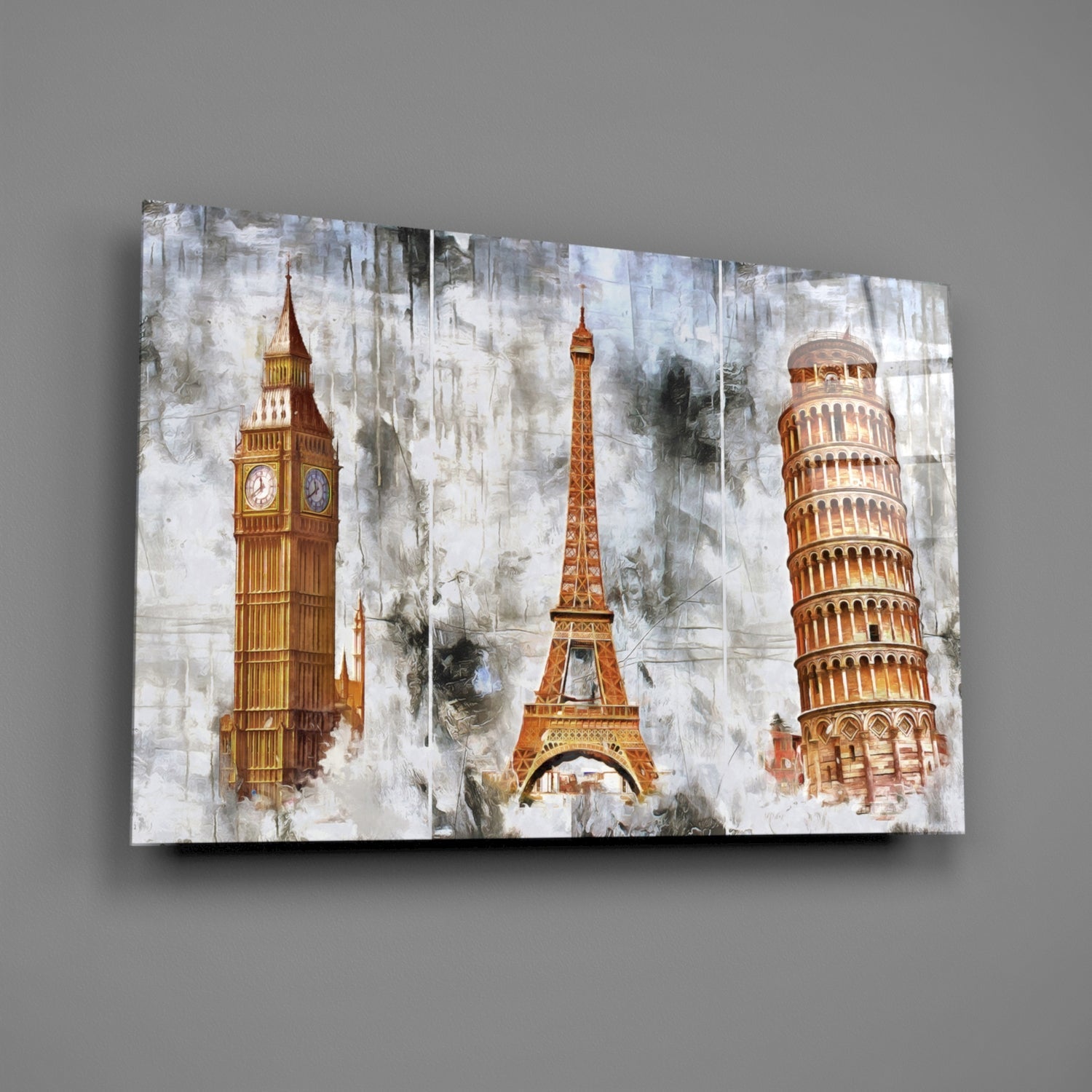 Glass wall art displaying Big Ben, Eiffel Tower, and Leaning Tower of Pisa against a distressed white and grey textured background.