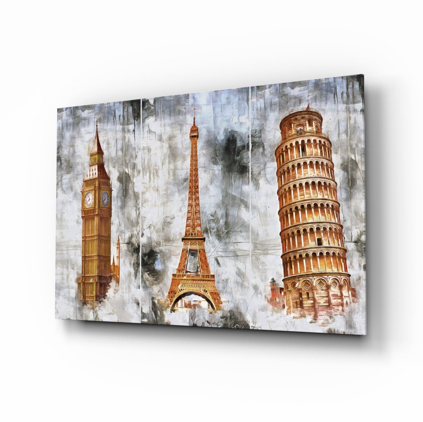 Glass wall art displaying Big Ben, Eiffel Tower, and Leaning Tower of Pisa in golden tones on weathered white background.