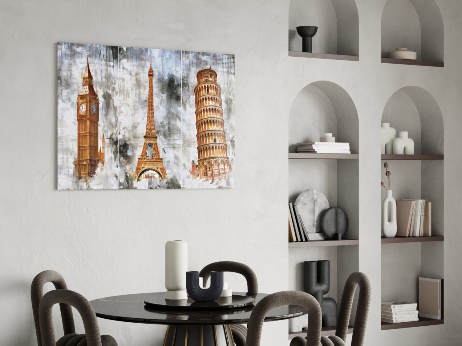 Famous Towers glass wall art displaying Big Ben, Eiffel Tower, and Leaning Tower of Pisa in gold tones on distressed white background, hung above round black dining table.