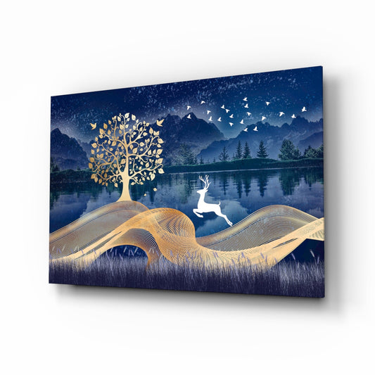 Glass wall art displaying a white leaping deer with golden tree and rolling hills against a deep blue nighttime landscape with mountains and lake.