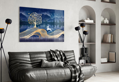 Magic Deer Glass Wall Art with gold tree and deer on blue landscape background, displayed above black leather sofa in modern living room.