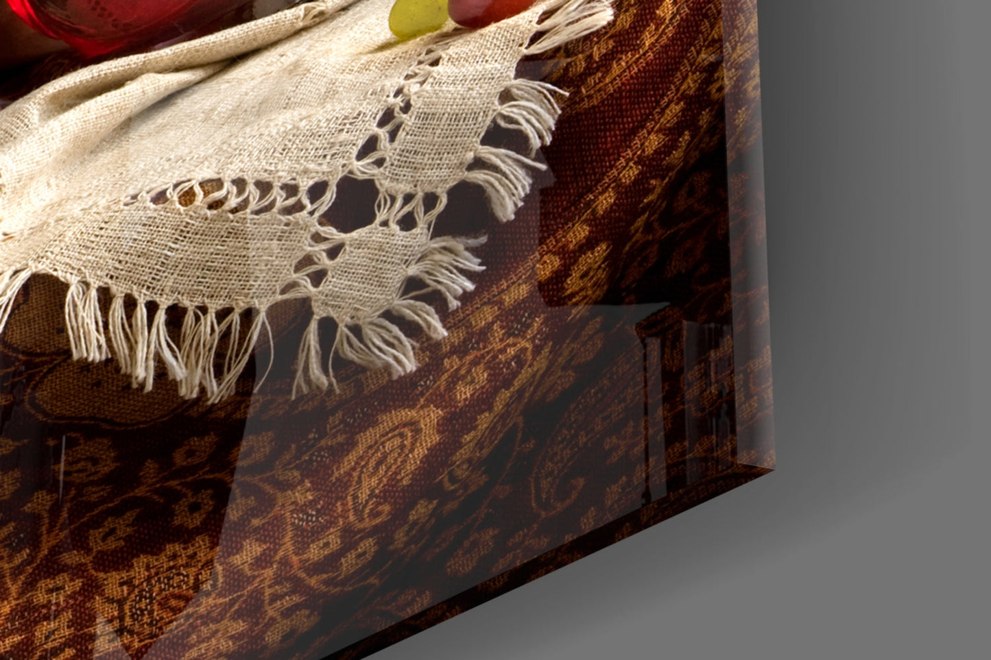 Close-up of cream linen fabric with frayed edges draped over brown patterned upholstered furniture.