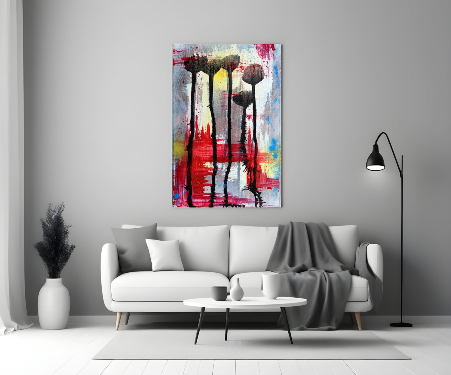 Colorful glass wall art with silhouetted flowers displayed above white sofa in modern living room interior.