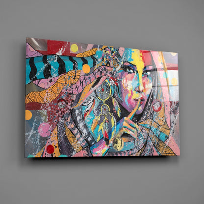 Colorful glass wall art featuring a stylized woman's face with feather earrings, geometric patterns, and vibrant splashes of pink, turquoise, yellow, and orange.