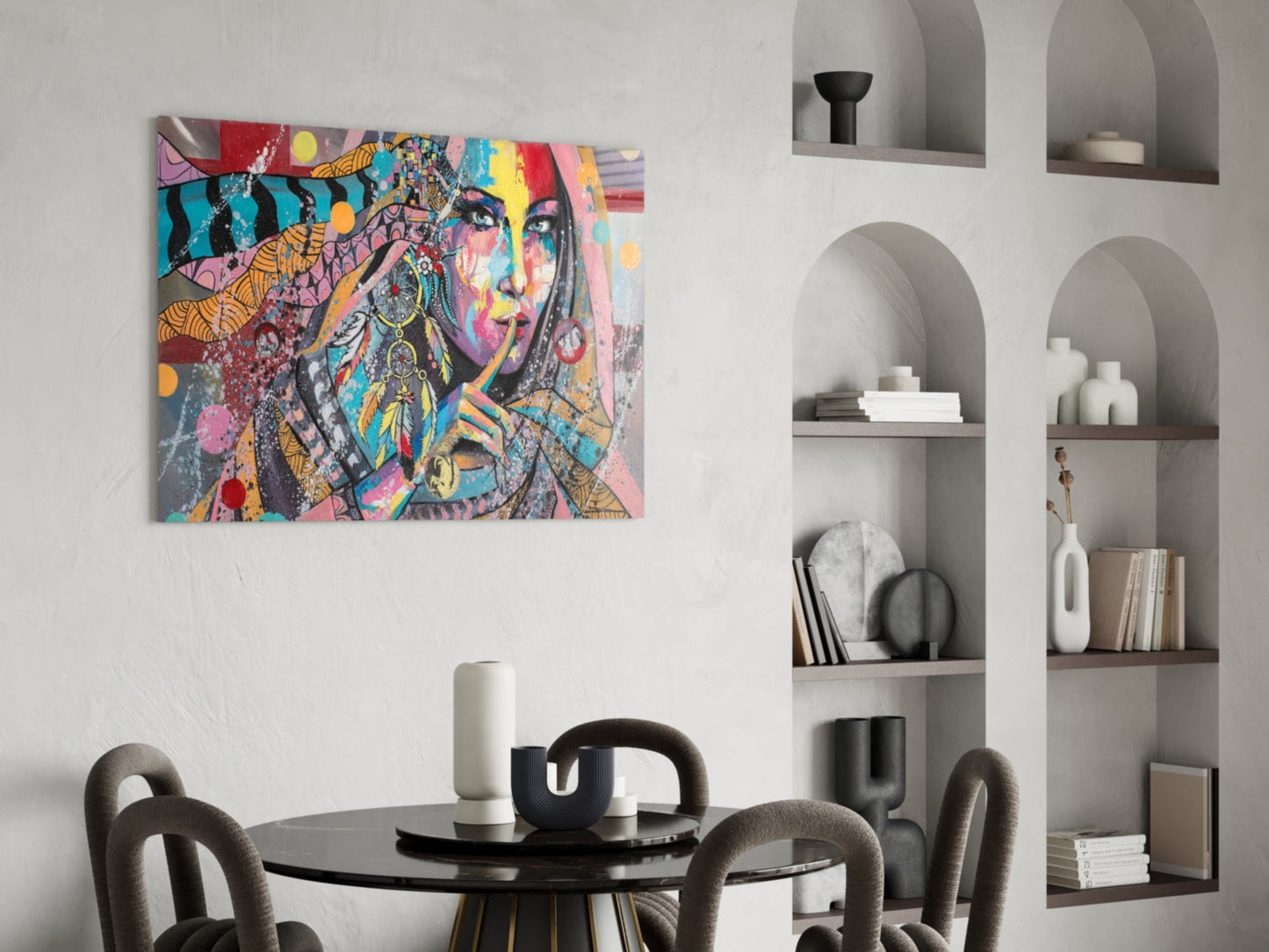 Colorful pop art portrait of a woman with vibrant geometric patterns displayed above a black round dining table with gray chairs.