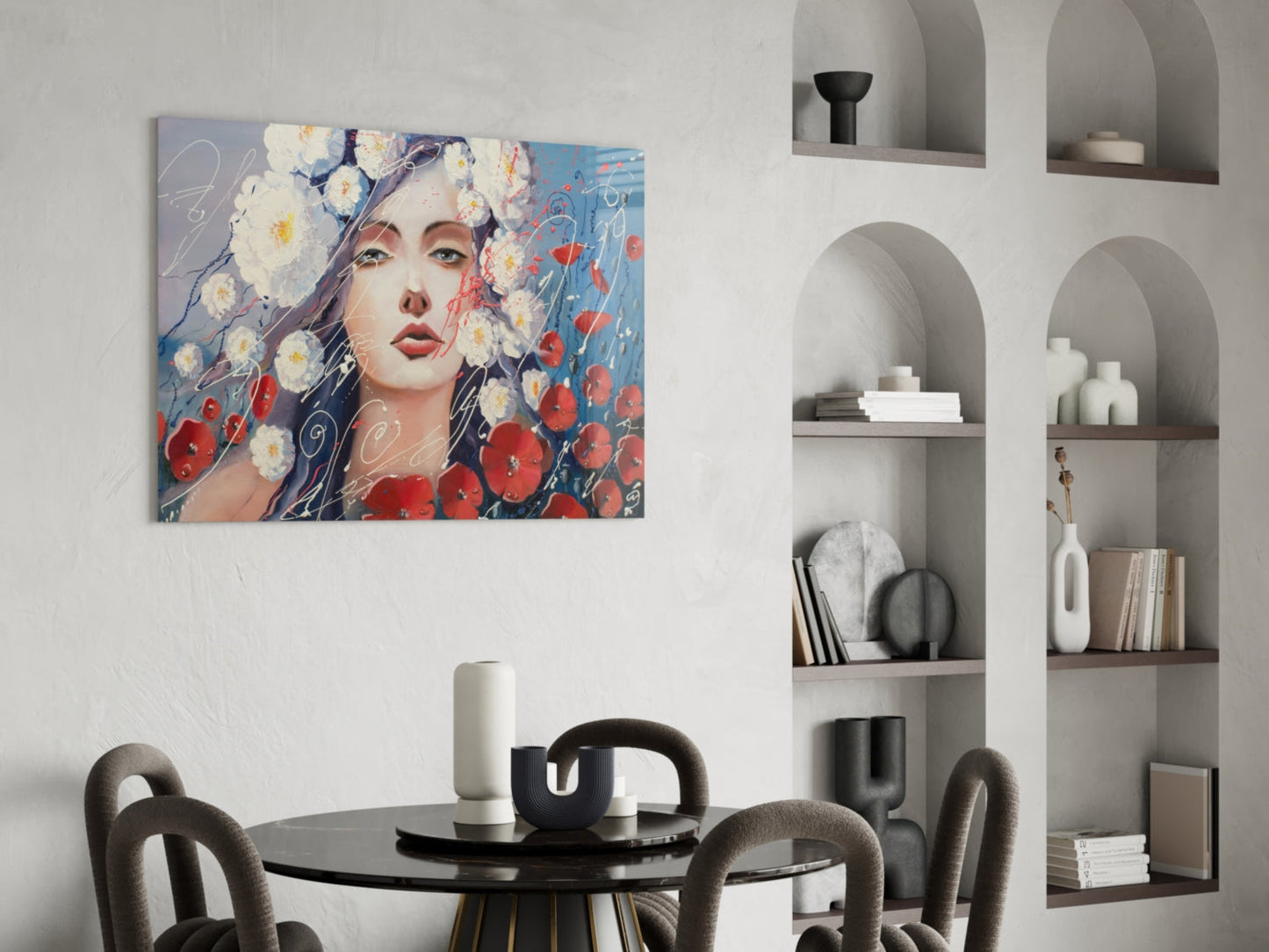 Modern dining room with colorful glass wall art depicting woman's face surrounded by red and white flowers above round black table.