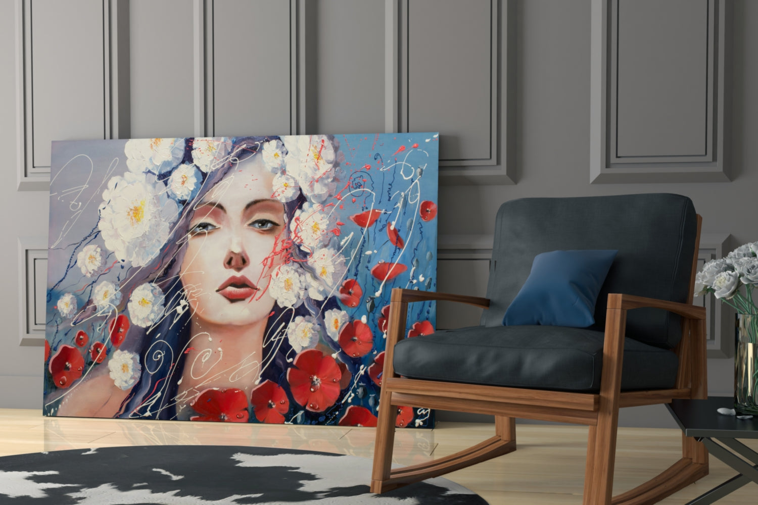 Glass wall art depicting a woman's face surrounded by white and red flowers against a blue background, displayed in a modern living room beside a wooden chair.