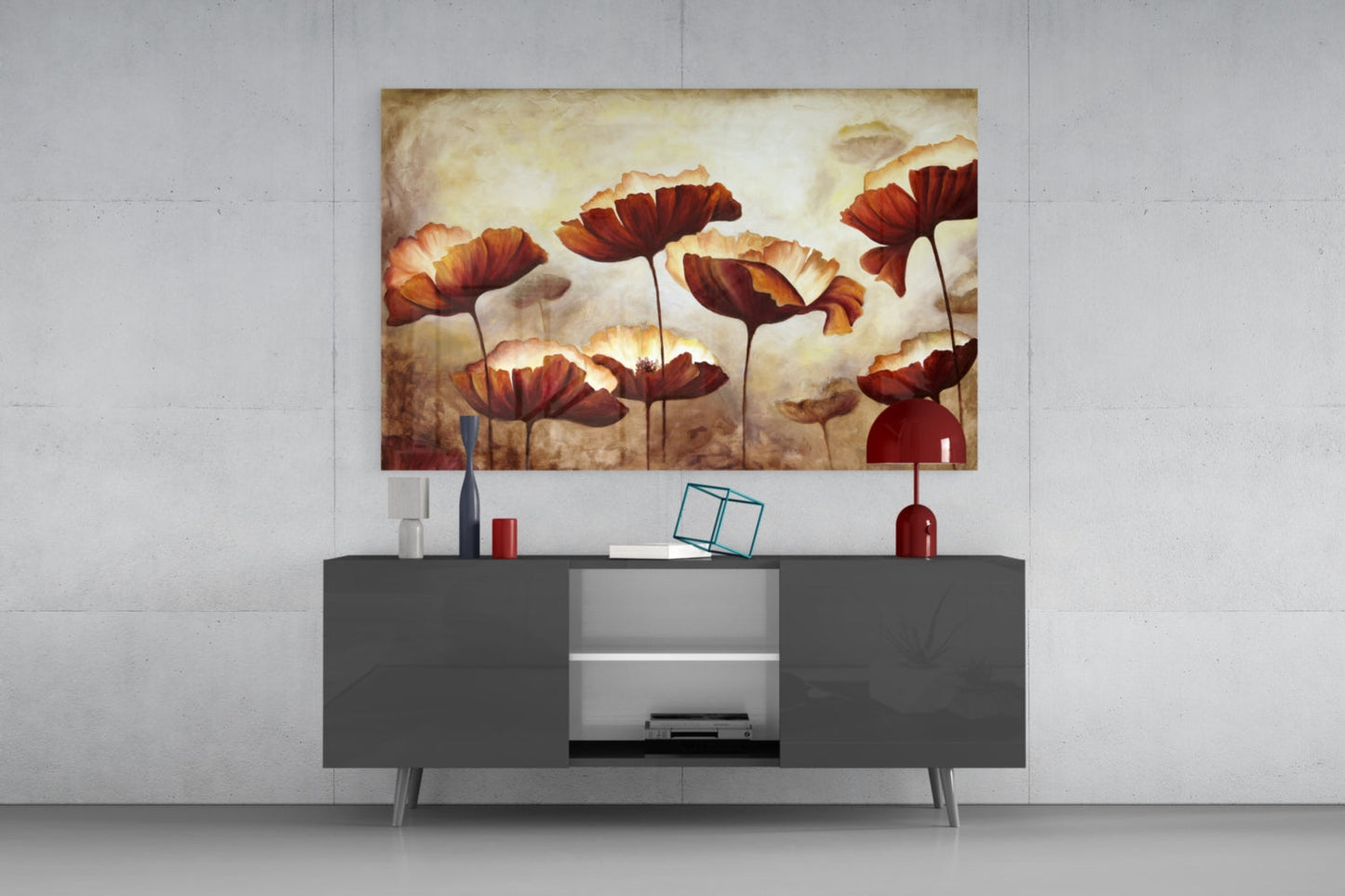 Red and orange poppy flowers with cream backgrounds displayed as glass wall art above a dark gray media console in a modern interior setting.