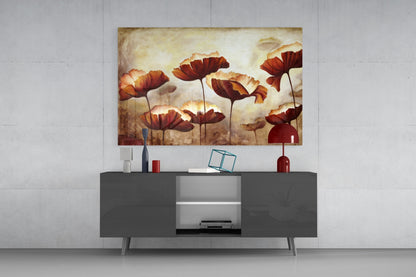 Red and orange poppy flowers with cream backgrounds displayed as glass wall art above a dark gray media console in a modern interior setting.