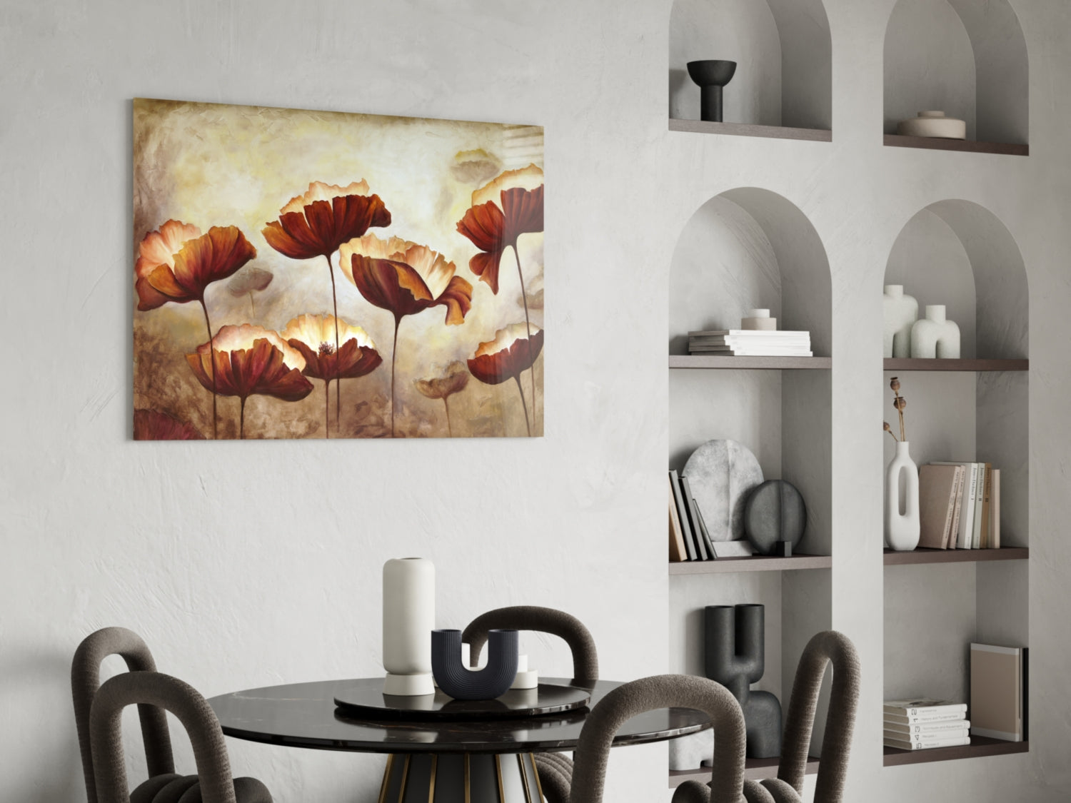 Red and orange poppy flowers with golden tones on glass art hanging above black dining table in modern interior.