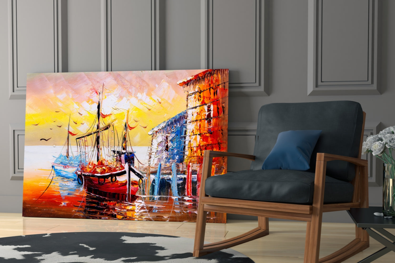 Colorful glass wall art depicting red and blue boats at sunset displayed beside a wooden rocking chair in a modern interior.