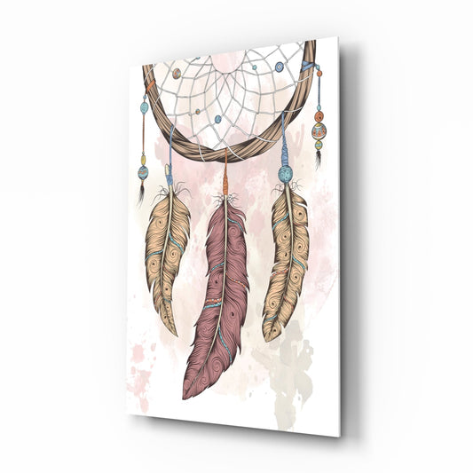 Angled three-quarter view of a glass wall art panel featuring a dreamcatcher with feathers in tan, burgundy, and gold tones against a white background with watercolor effects.