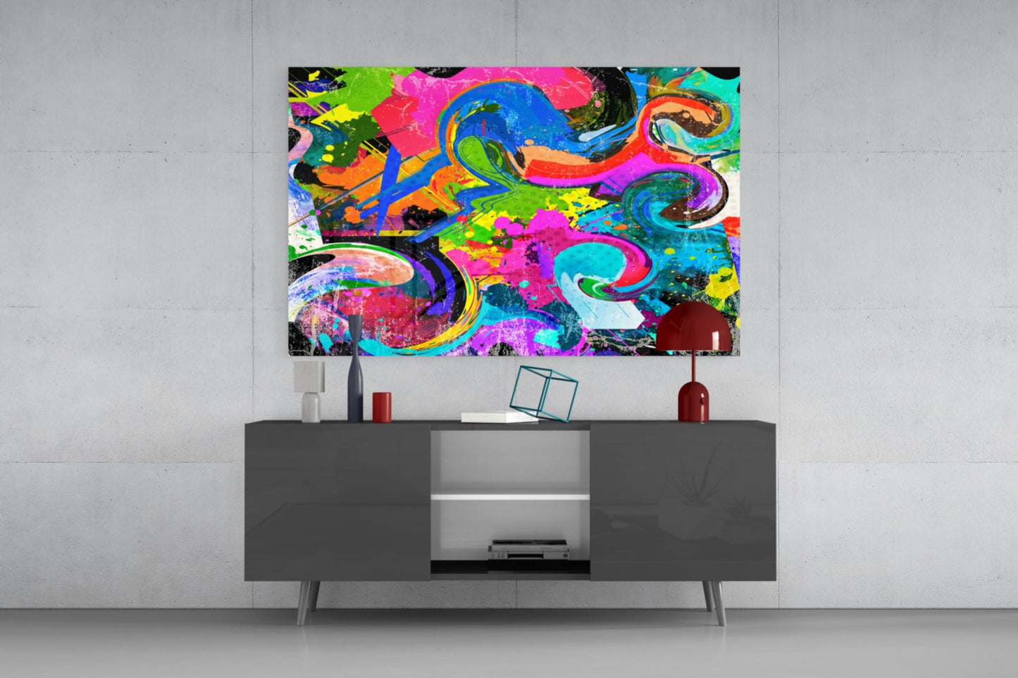 Vibrant multicolored abstract swirl glass art displayed above dark console table in modern interior setting.