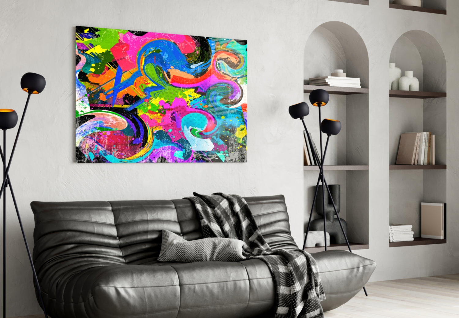 Vibrant multicolored abstract Ebruli glass artwork hung above black leather sofa in modern white interior space.