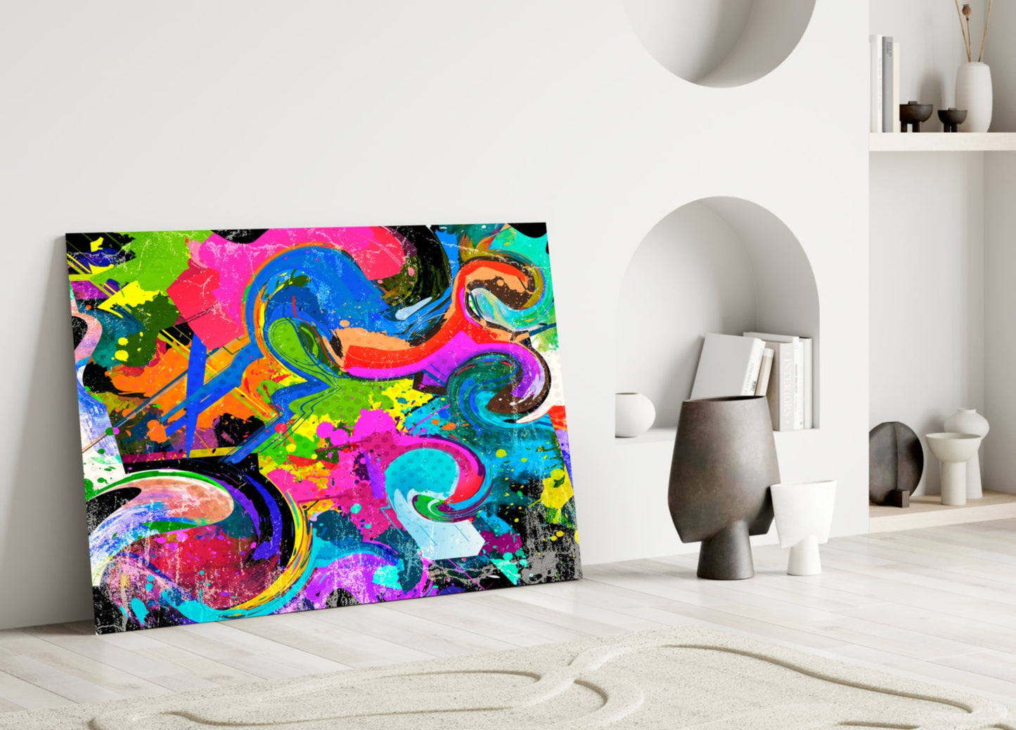 Vibrant Ebruli glass wall art with neon pink, blue, green, and yellow abstract swirls displayed against white wall in minimalist interior.