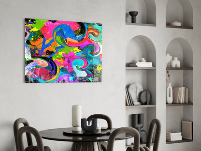 Vibrant multicolored abstract Ebruli glass art with swirling patterns in pink, blue, yellow, and green hanging above a dining table.