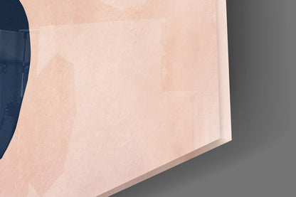 Close-up angled view of abstract brown glass wall art showing soft peachy-tan tones with subtle gradients and shadow details.