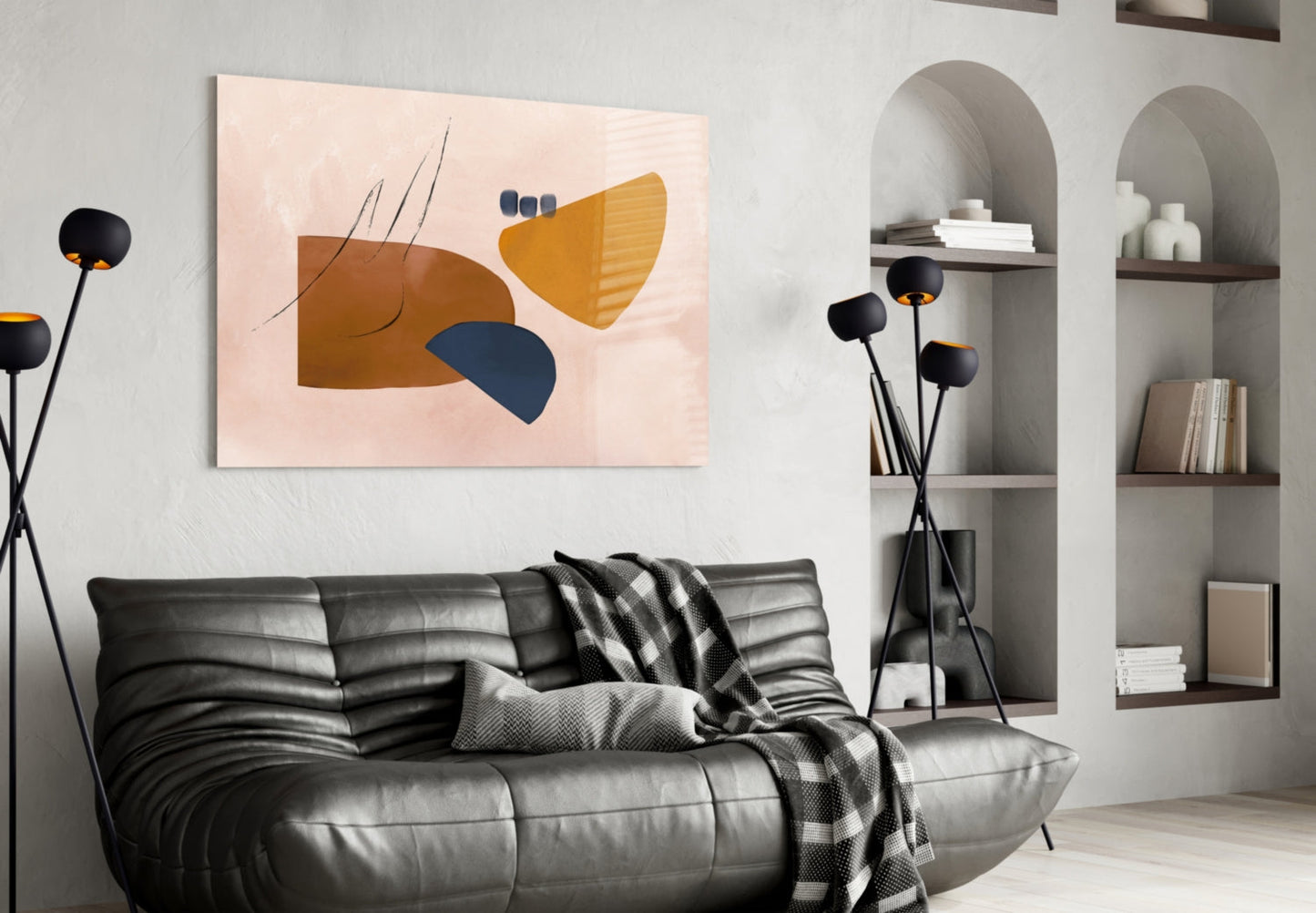 Abstract brown glass wall art with navy blue and yellow geometric shapes displayed above black leather sofa in modern living room.