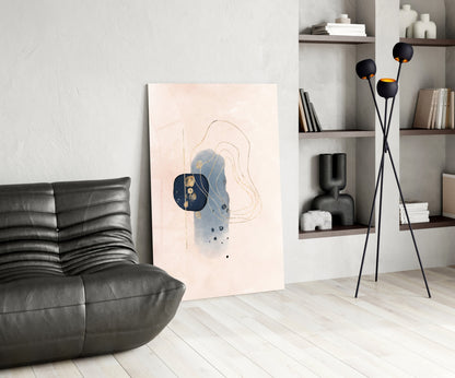 Abstract beige glass wall art with navy blue circular and curved line design displayed in modern living room setting.