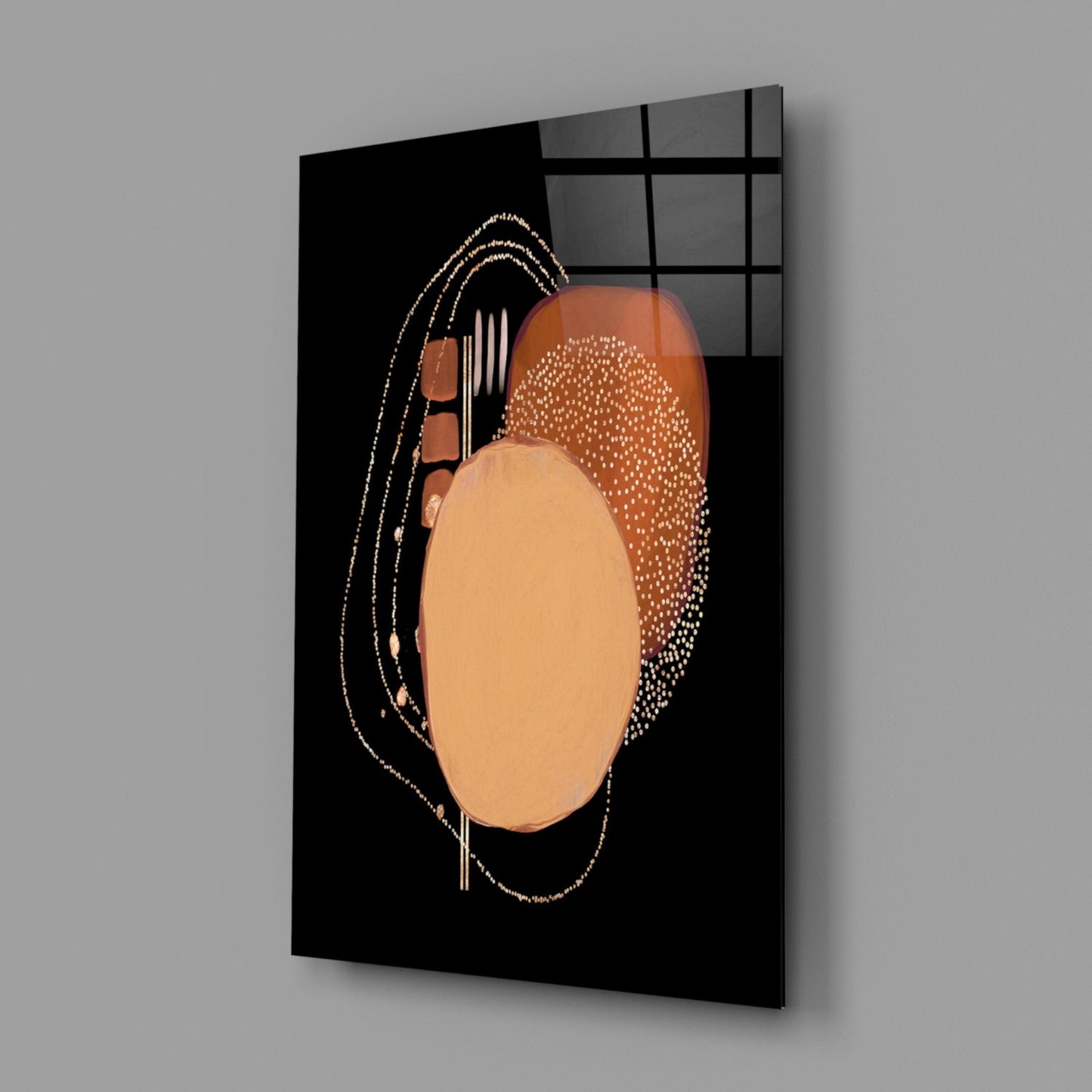 Black glass wall panel displaying abstract geometric design with peach and bronze circular shapes, decorative line details, and gridded window reflection in background.