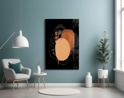 Abstract black glass wall art featuring orange and tan geometric shapes with white line details displayed in a modern teal room setting.
