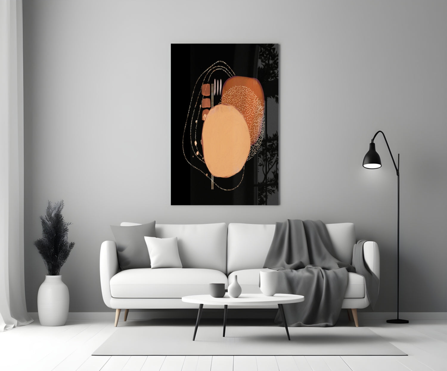 Abstract black glass wall art with orange and peach circles and fork design, displayed above white sofa in modern living room.